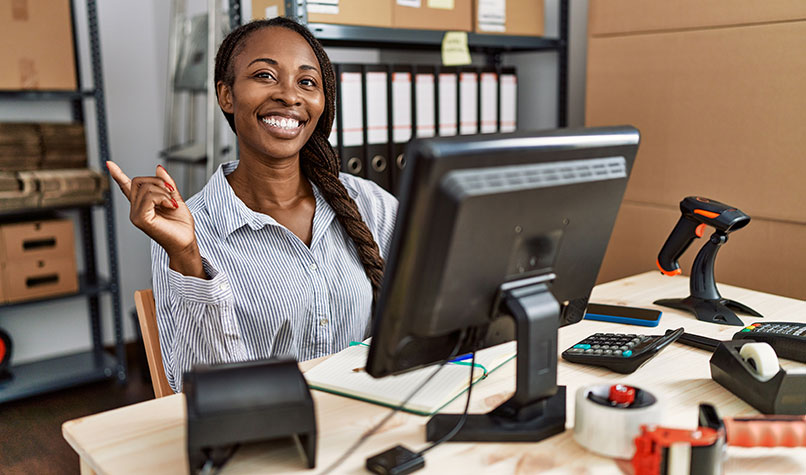 Smiling bookkeeper sat behind a computer