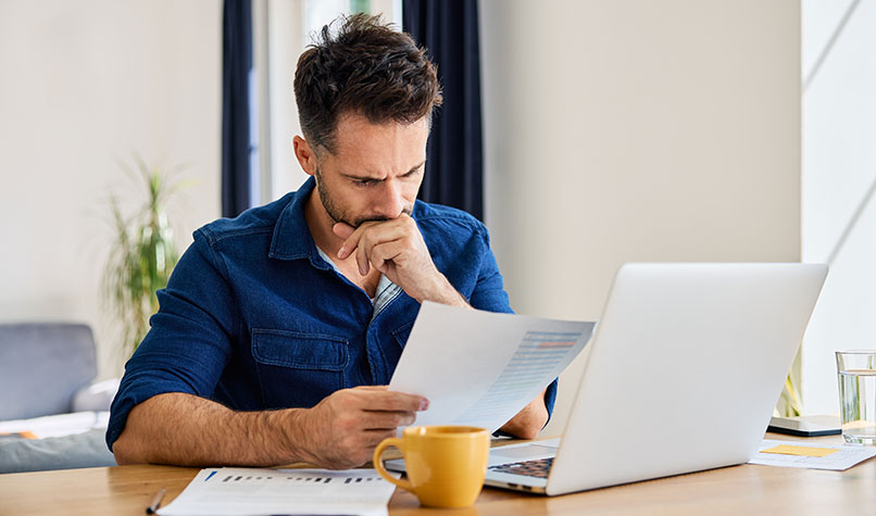 Man thinking while looking at a document