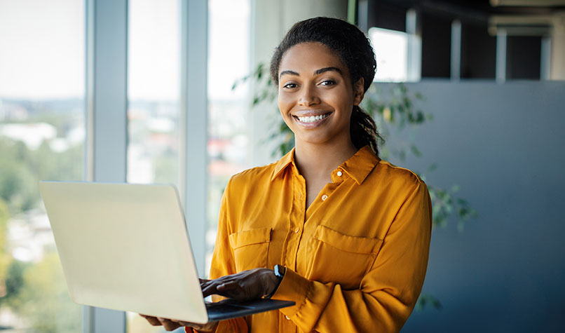 Woman owner of a small business smiling at a tablet computer