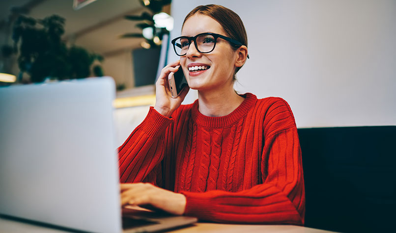 Someone making calcuations on a laptop
