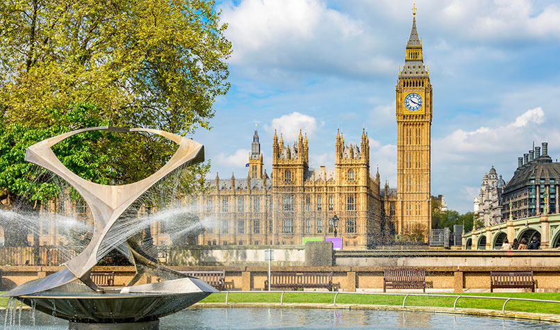 The UK Houses of Parliament with a fountain in the foreground