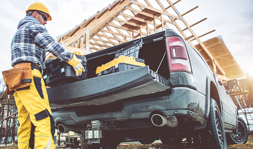 Builder unloading from the back of a pick up truck