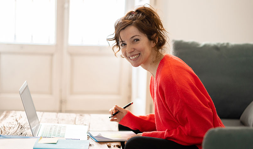 A woman wearing red working at a desk