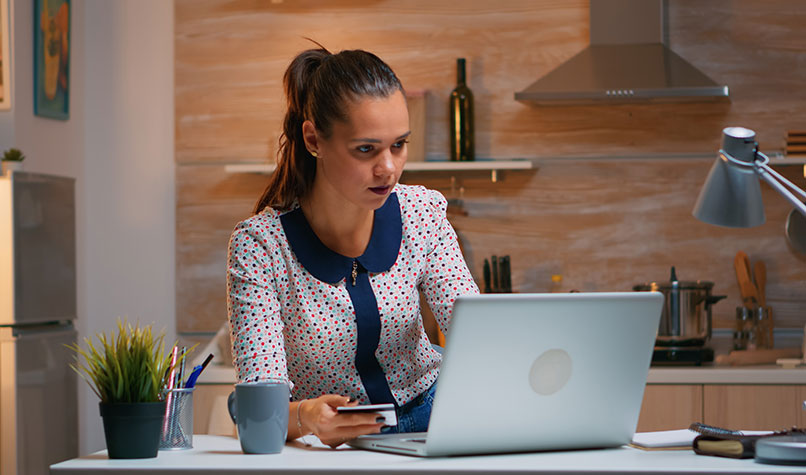 A woman looking confused at her laptop