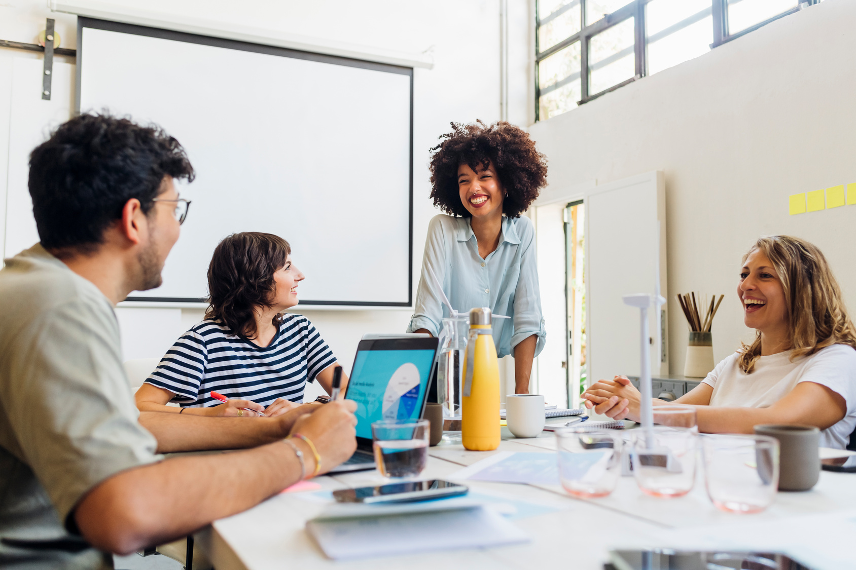 Employed staff in a discussion around a meeting room table.